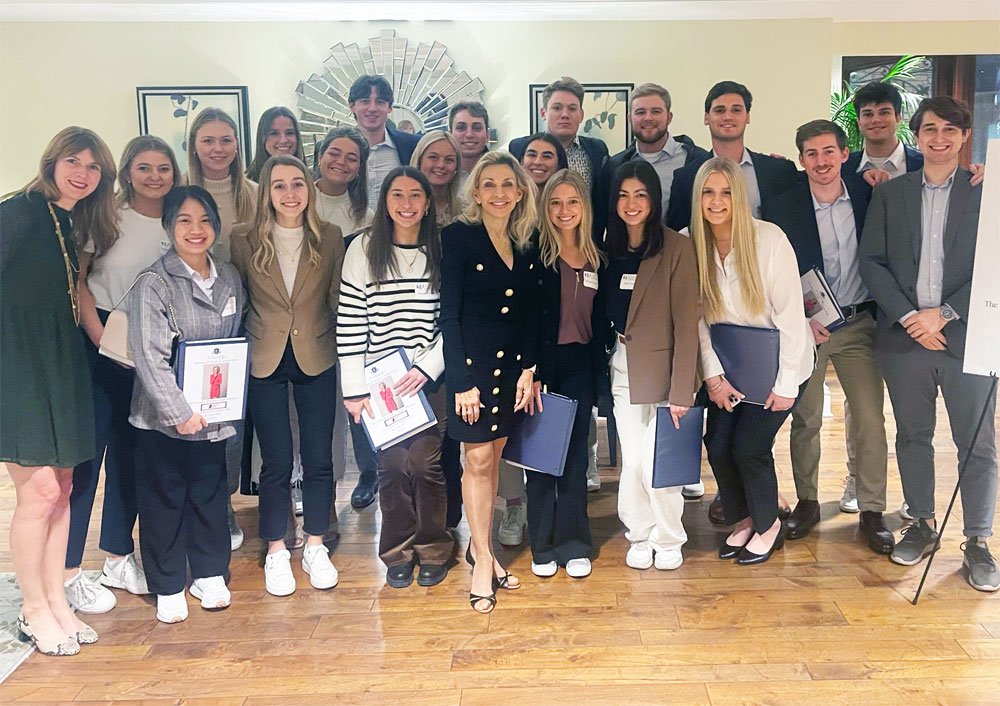 Group of young professionals holding certificates indoors